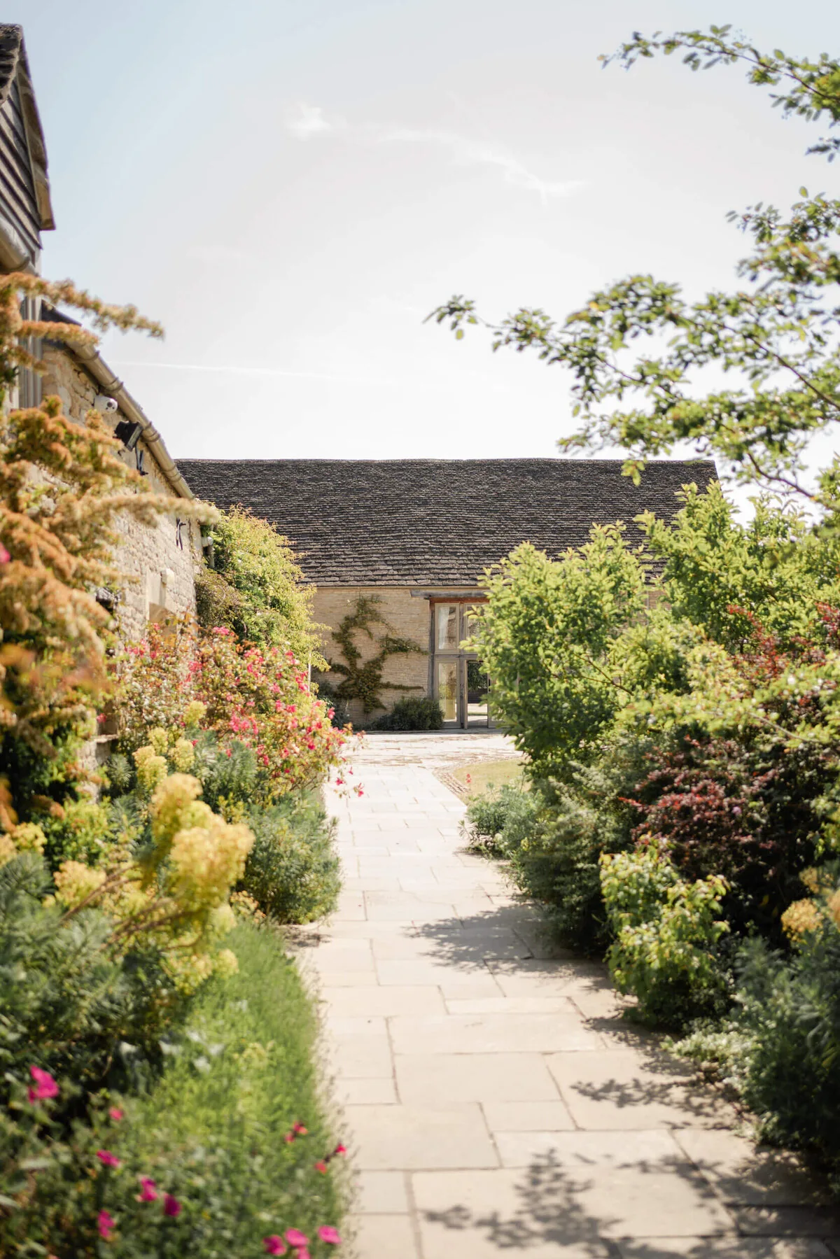 Caswell House exterior and summer gardens in warm sunshine