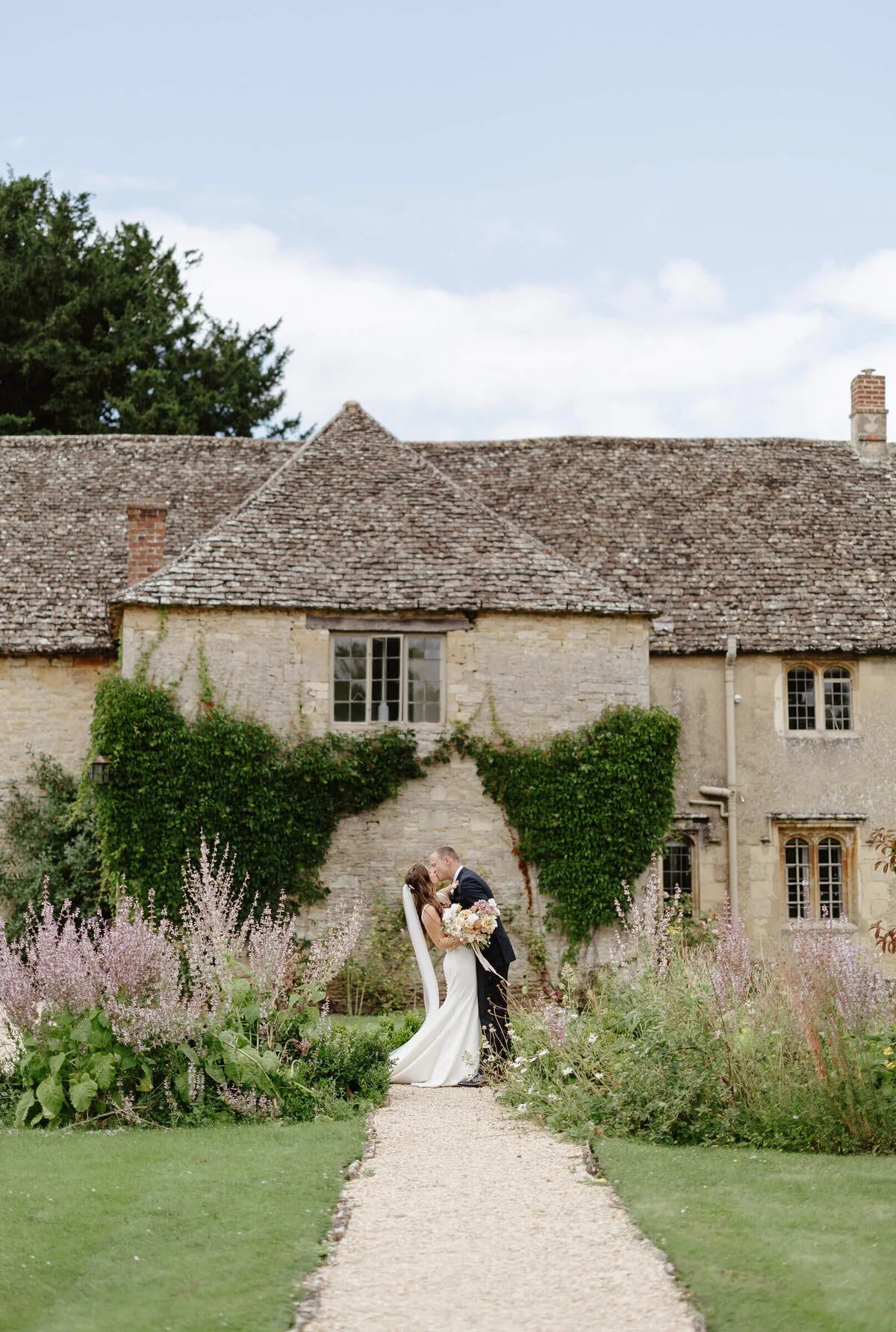 A bride and groom in the lavender garden at Caswell House